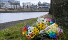 Tributes laid on banks of the River Dee for Eliza and Henrietta Huszti.