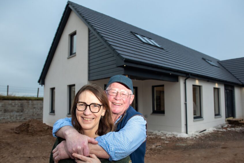 Derek and Linda outside the home they've built for their retirement. 