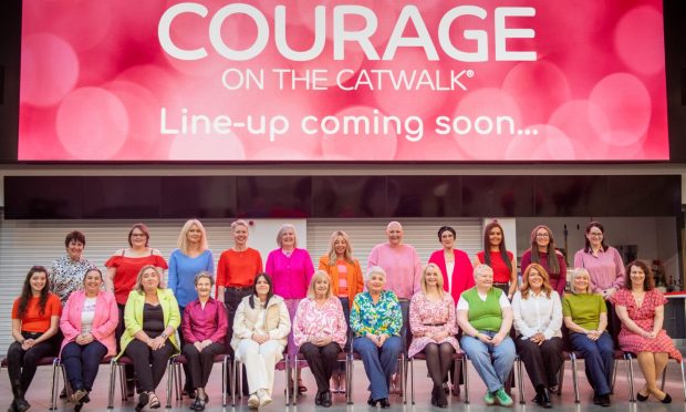 Courage on the Catwalk models in front of Courage sign