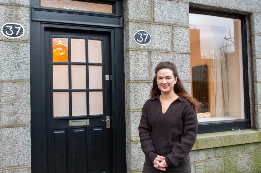 Jo Flett standing outside entrance to 37 Huntly Street in Aberdeen 