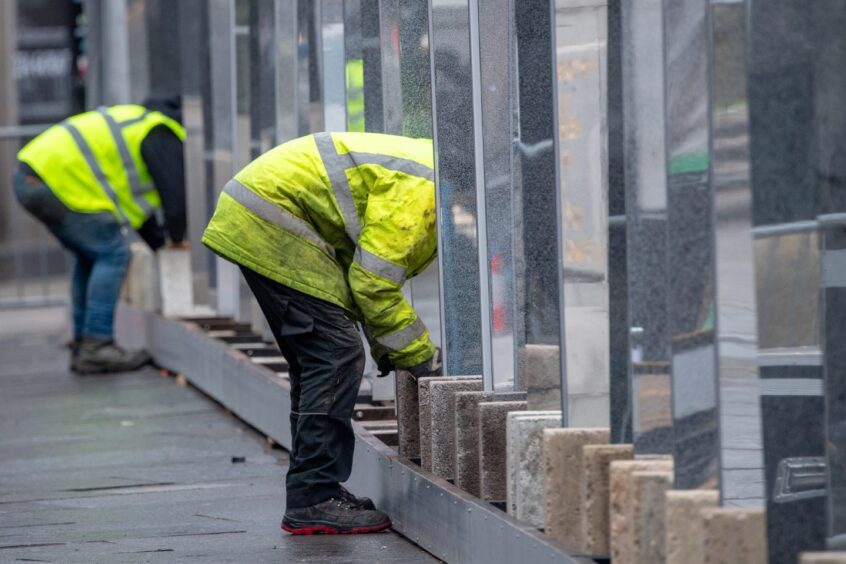 High-vis jackets and mirrors on street