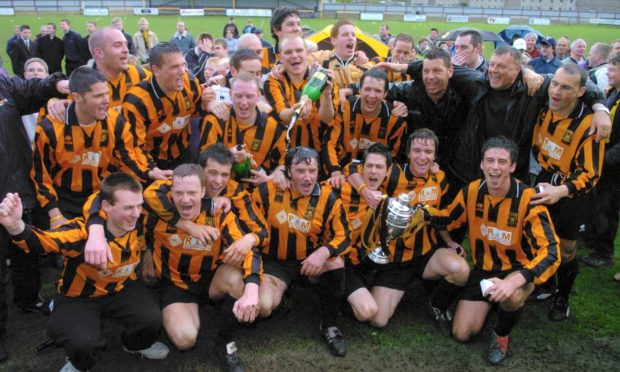 Huntly's players and management celebrate winning the Breedon Highland League in 2005.