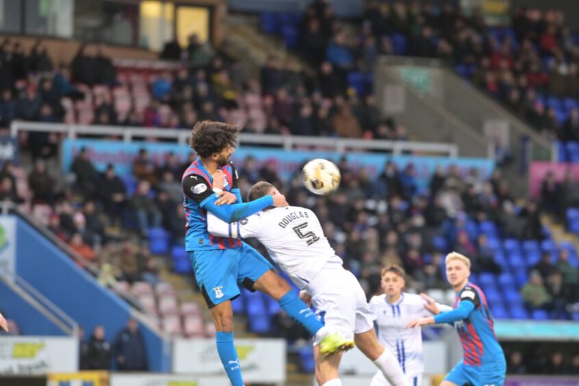 Inverness Caledonian Thistle defender Remi Savage wins his header against Queen of the South's Matthew Douglas in the SPFL League One match at the Caledonian Stadium, Inverness, on Saturday, February 1, 2025. ICTFC were 1-0 winners. 