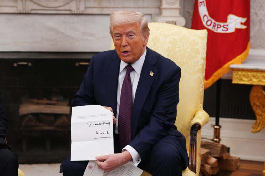 Trump holding up letter from King Charles