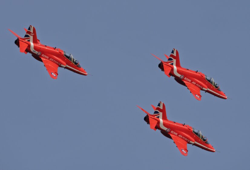 Three Red Arrows aircrafts up close.