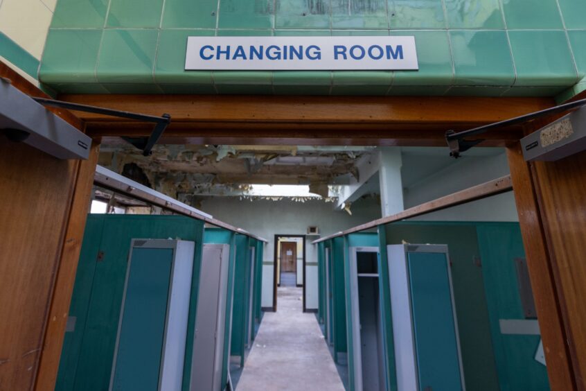 Changing rooms sign with cubicles in the background 