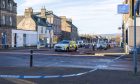 6 February 2025. High Street at Castle Road,Invergordon,Scotland. This is the taoped off scene of alleged stabbing incident. Police remain guarding the scene. Credit - Jasperimage