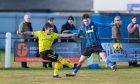 Nairn County's Andrew Greig, left, is put under pressure by Ali Nixon of Strathspey. Pictures by Jasperimage.