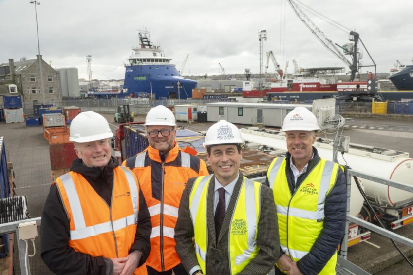 Adrian Watson, chief executive of Aberdeen Inspired, Bob Smith, operations manager of Peterson Energy Logistics, Martin Greig, Aberdeen City Council's culture spokesman, and Bob Sanguinetti, chief executive of Port of Aberdeen. wearing hard hats at Peterson Seabase in Aberdeen