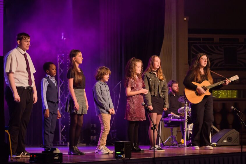 children singing on stage