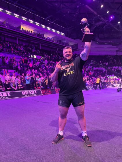 Luke Stoltman holds aloft his trophy after being crowned Britain's Strongest Man.