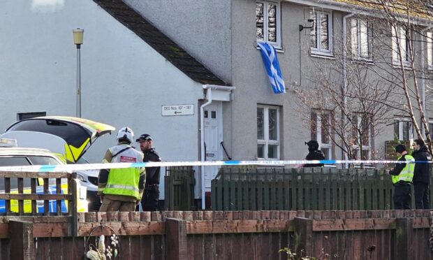 officers and armed officers outside property