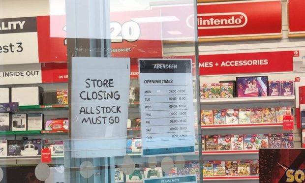 Store closing sign in window of Game store