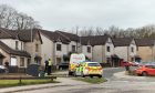 Police vehicles outside a property in Tradlin Circle, Blackburn, during a search of the dwelling. Image: DC Thomson