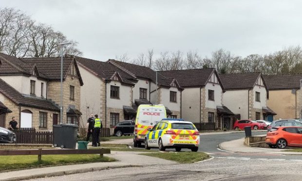 Police at the scene of the raid in Tradlin Circle, Blackburn. Image: DC Thomson.