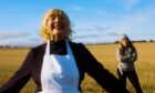 Woman singing in a field inspired by sound of music