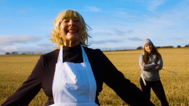 Woman singing in a field inspired by sound of music