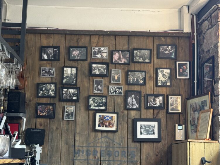 framed pictures on the wall at MacGregor's pub