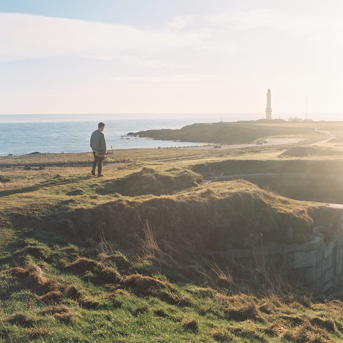 Aberdeen saxophonist Matthew Kilner with the Girdle Ness Lighthouse in Aberdeen behind him. Image by Mark Quinn