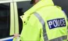 A police officer in a yellow fluorescent jacket.