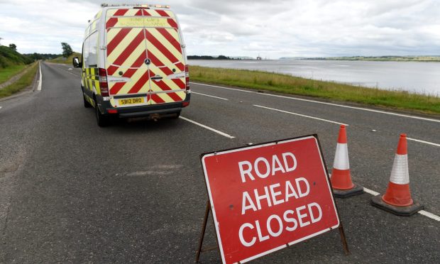 Red Road closure ahead sign with white bear Scotland van.