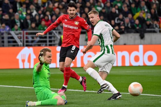 Goalie Denes Dibusz (L) of Ferencvaros in action in front of teammate Mats Knoester (R) and Sardar Azmoun (C) of Bayer Leverkusen during the soccer Europa League round of 16 second leg Image: Shutterstock.