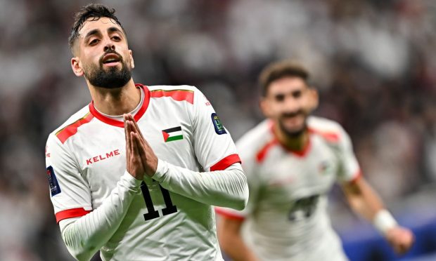 Oday Dabbagh celebrates a goal for Palestine against Qatar. Image: Shutterstock.