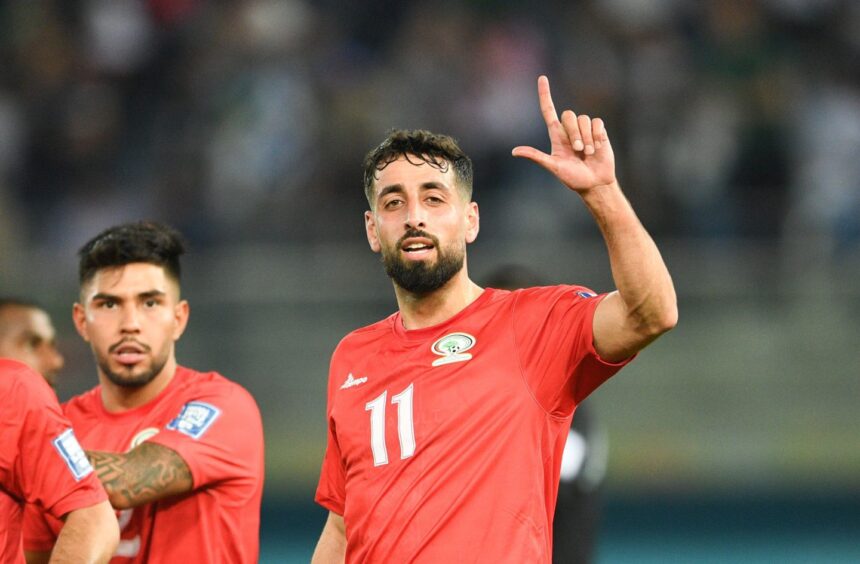 Oday Dabbagh (R) of Palestine celebrates scoring against Bangladesh. Image: Shutterstock