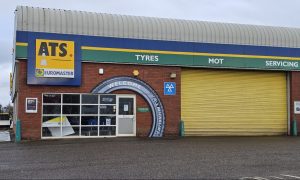 Facade of ATS tyre centre with its signature yellow shutters.