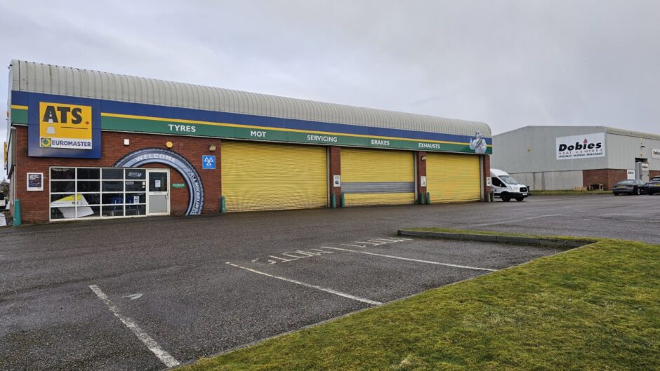 Facade of ATS tyre centre with its signature yellow shutters.