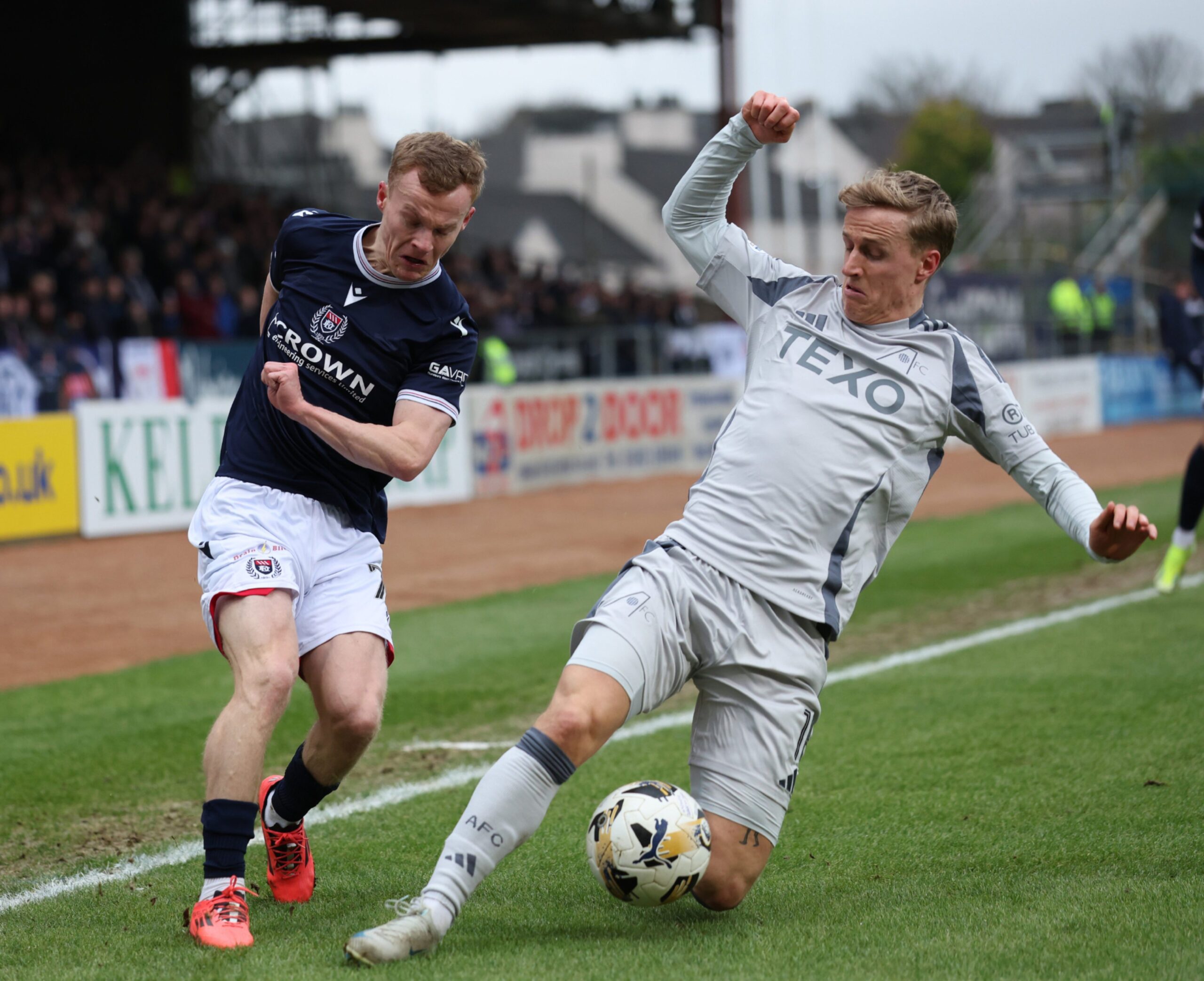 Scott Tiffoney of Dundee and Aberdeen's Jeppe Okkels in action. Image: Shutterstock 