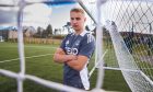 Aberdeen winger Topi Keskinen poses behind the goal nets at the club's Cormack Park training complex.