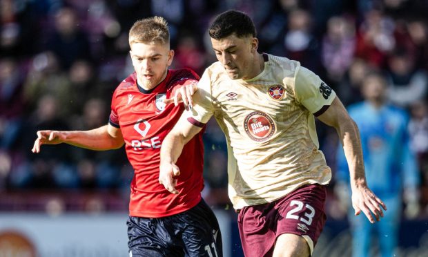 Ross County's Kieran Phillips, left, and Hearts' Lewis Neilson compete for possession during the SPFL Premiership match at Tynecastle Stadium, Edinburgh, on March 15, 2025.