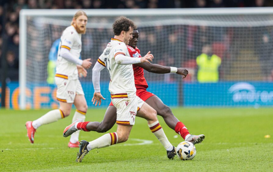 Aberdeen's Pape Habib Gueye fouls Motherwell's Andy Halliday. Image: SNS.