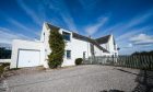 15 Broadhaven Road a large white house with big blue sky above