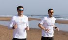 Bronson Larkins, left, and son Jayden training on Balmedie beach. The duo are off to southern Morocco in April for the Marathon des Sables. Image: Ethan Williams/DC Thomson