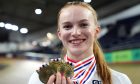 Lauren Bell smiles as she displays her three gold medals following day three of the Lloyds Bank British National Track Championships in Manchester.