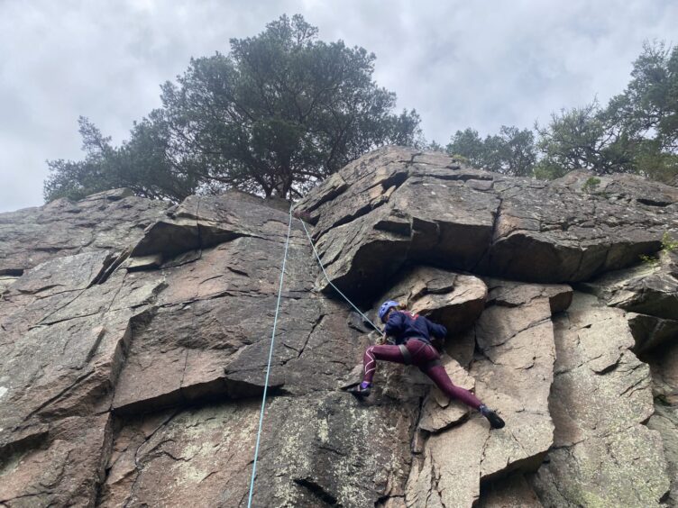 Imogene Newland climbing Brut at Pass of Ballater in July 2024