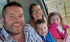 George Ross, known as Dod, with wife Loretta and children Lucas and Keira in his "Fergie" tractor.