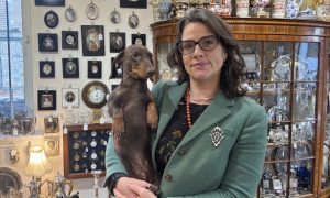 Sarah Marr of Iain Marr Antiques in her shop with her dog