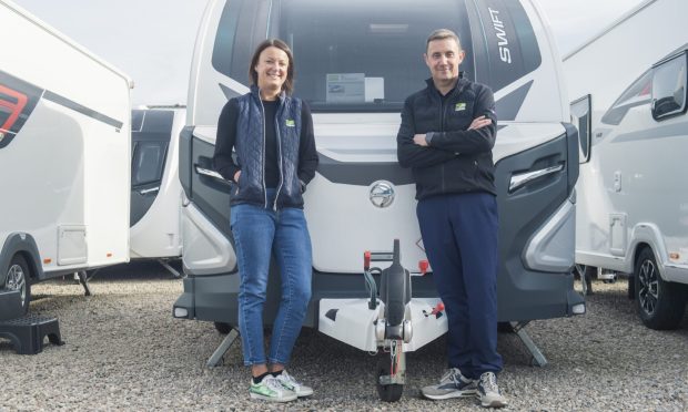 Donna and Stuart Harper standing with caravan.