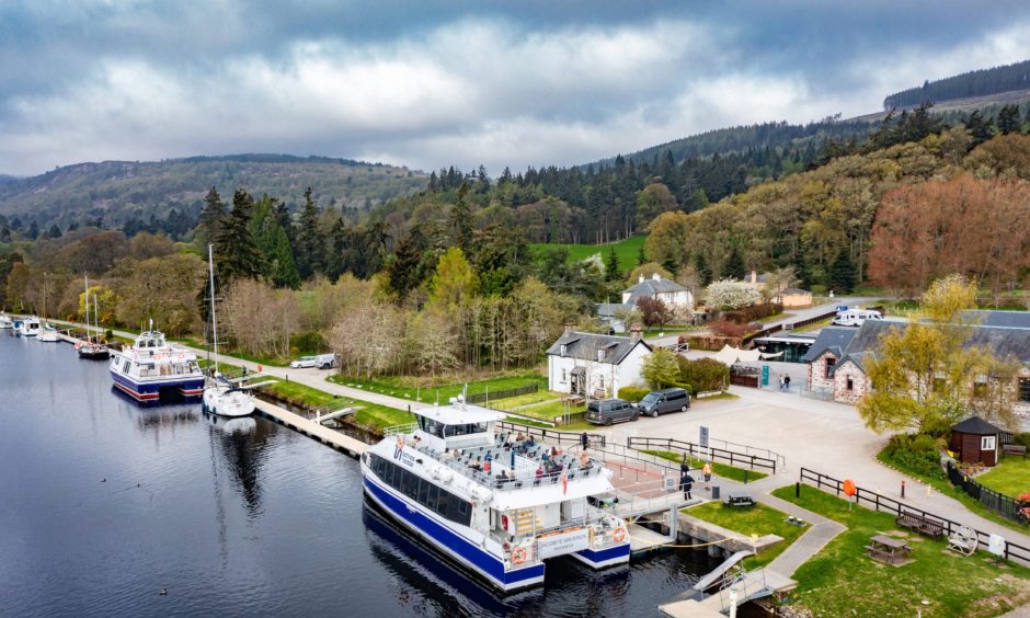 boats moored at jetties on Loch Ness in an aerial shot of Dochgarroch, which is the perfect distance from Inverness for a family cycle 