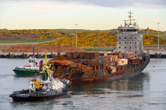 The burnt out Solong container ship being tugged into Aberdeen's South Harbour. Image: Kenny Elrick/DC Thomson