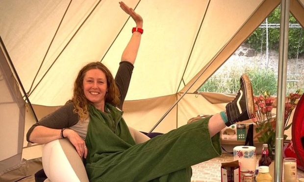 a smiling Lindsay Allardyce with her feet up in a large tent