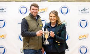 Melissa Buchan, being presented with the "spotlight" trophy by Texel Sheep Society director David McKerrow Jnr.