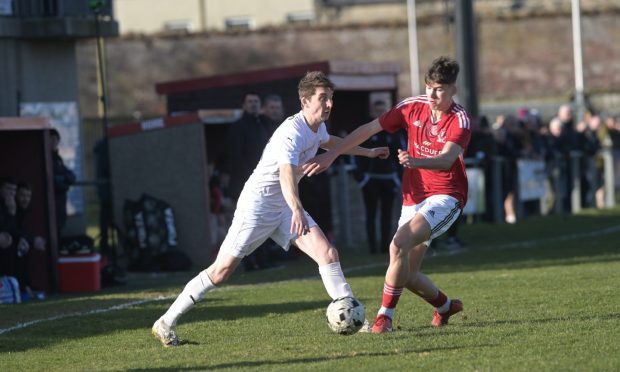 Colin Williamson, left, of Brora and Deveronvale's Jack Mitchell battle for the ball. Pictures by Sandy McCook/DC Thomson.