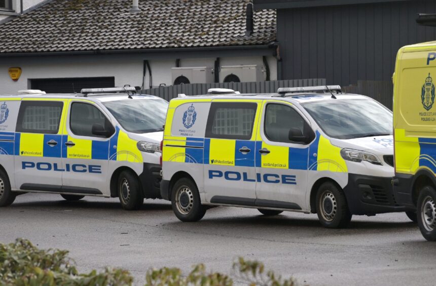 Police vehicles lined up at scene of fire at Fairways Business Park.