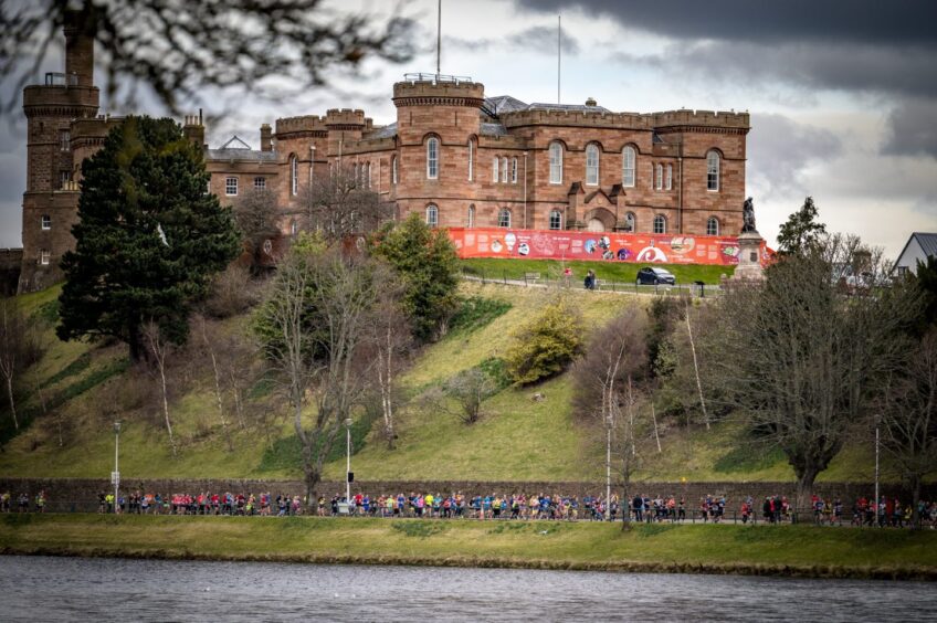 Runners running below Inverness Castle.