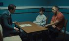 Two men and boy in an interview room in a scene from Netflix drama Adolescence