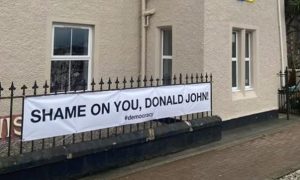 The poster about Donald Trump outside a shop in Stornoway